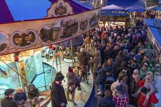 Historic horse-drawn carousel at the Christmas market on the Heumarkt in the old town of Cologne,