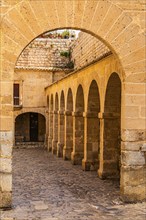 Archway and arcades at the Portal de des Tales in the old town of Eivissa, Ibiza Town, Ibiza,