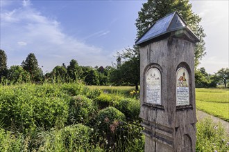 Old wooden information board in front of Schlehdorf Monastery, Schlehdorf, spring, sunny, Bavaria,