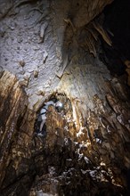 Man in a stalactite cave, Terciopelo Cave, Barra Honda National Park, Costa Rica, Central America