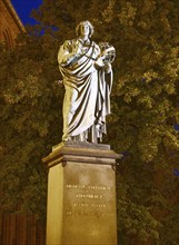 Monument to Nicolaus Copernicus in the medieval old town of Thorn, illuminated in the evening. The