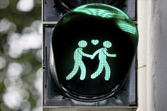 Green pedestrian traffic light with two men and heart, male traffic light couple, homosexual love,