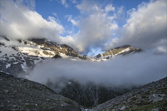 Cloudy mountain landscape with summit Hochsteller and Griesferner with snow and glacier, Berliner