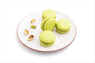 Green macarons or macaroons cakes isolated on white background. Side view, close up