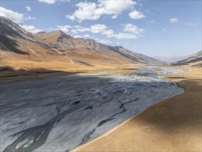 Aerial view, Burkhan mountain valley with meandering river, barren dramatic mountain landscape,