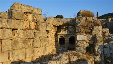 Ancient stone ruins with a small opening and visible sky above, Peirene Fountain, Archaeological