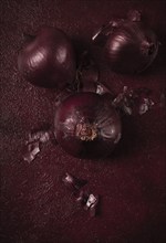 Red onion, fresh, raw, on a dark background, top view