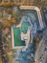 Drone image of an outdoor pool during twilight hours in an urban environment with frozen water ENCW