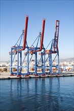 Cranes standing on quayside in the port of Malaga, Spain, Europe