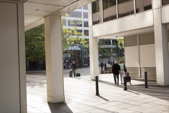 Modern architecture people walking between insurance company offices in the Tricentre development