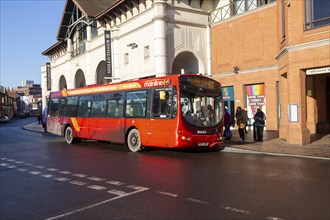 Red single decker bus Mainline 66 route to Martlesham Tesco passengers boarding in town centre,