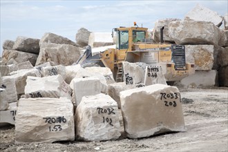 Heavy machinery at work in a stone quarry on the Isle of Portland, Dorset, England, UK