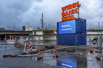 Central station, construction site for a new building, illuminated advertising, neon sign, digital