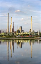 Industrial backdrop of the ThyssenKrupp Steel steelworks in Bruckhausen, on the Rhine, cargo ship,