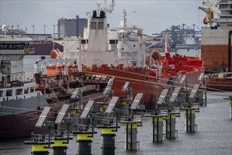 Petroleum harbour, tankers waiting for new loads in the Europoort port, mooring lines as so-called