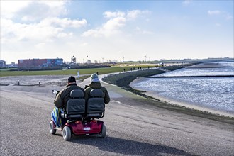 Scooter, motorised buggy, dyke walk on the East Frisian coast near Norddeich, Lower Saxony,