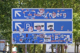 Motorway sign covered with stickers at a motorway service area, A6 motorway, Baden-Württemberg,