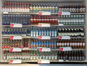 Shelves with bottles of alcohol World Duty Free shop, Stansted airport, Essex, England, UK