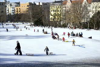 Tobogganing fun in Berlin's snow-covered Viktoriapark. Snow and icy cold continue to dominate the