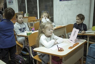 Pupils in a classroom in one of the metro schools in Kharkiv. Classrooms were set up in various