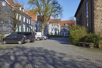 Church square with residential buildings and façade of St George's Church in the old town centre of