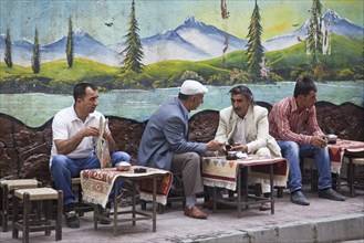 Turkish and Kurdish men having tea at a sidewalk cafe in the city Van, Eastern Turkey