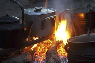 Boiling water and preparing food on open wood fire, Okavango Delta, Botswana, Africa