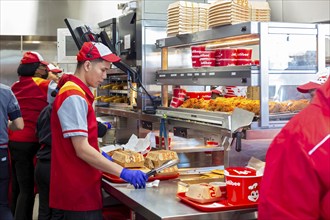 Sterling Heights, Michigan, Workers serve up Chickenjoy fried chicken at Jollibee, a Filipino fast