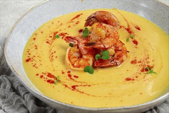 Pumpkin cream soup with shrimp, herbs and spices, homemade, no people