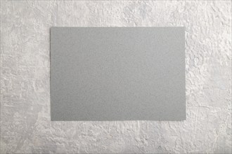 Gray paper business card, mockup on gray concrete background. Blank, flat lay, top view, still