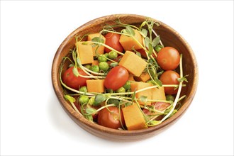 Vegetarian vegetable salad of tomatoes, pumpkin, microgreen pea sprouts isolated on white