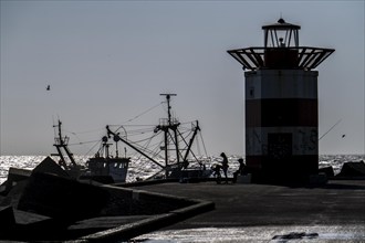 Fishing vessel TH10 DIRKJE, off the coast of Scheveningen, The Hague, with spread nets, beacon of