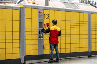 DHL parcel station, DHL employee operating the parcel pick-up and dispatch station, Frankfurt am