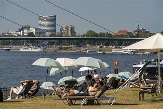 The city beach on the Rhine near Düsseldorf, riverside promenade, by the Rheinkniebrücke bridge,