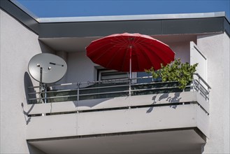 Balcony, balcony with parasol and TV satellite antenna and green plant, apartment blocks, Mülheim