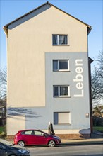 Residential buildings, rented flat, façade with the inscription Leben, on Adolf-Schmidt-Strasse,