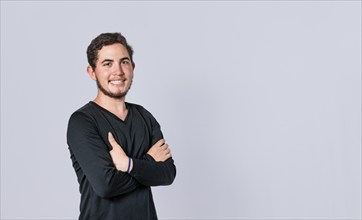 Happy handsome man with crossed arms, portrait of an attractive guy with crossed arms on isolated