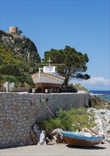 A boat on dry land against a picturesque backdrop with another boat, Limeni, Areopoli, Laconia,