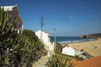 Colourful holiday homes and beach, Monte Clérigo, Atlantic coast, Algarve, Portugal, Europe