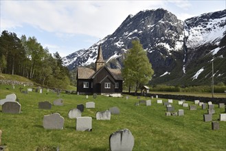 Wooden church with gravestones in Norway