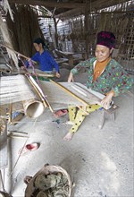 Vietnamese woman from the Hmong minority weave linen fabric, Lung Tam linen weaving mill, Ha Giang