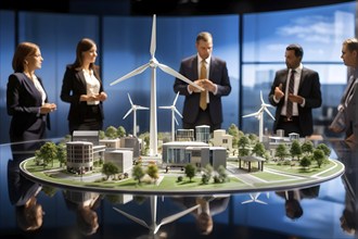 Business professionals engaged with a scale model of a wind turbine adjacent to miniature houses,