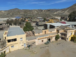 An abandoned western town in a dry desert landscape in sunny weather, aerial view, Fort Bravo,