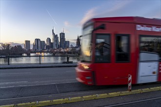 Skyline of the city centre of Frankfurt am Main, river Main, dusk, tram on the Ignatz-Bubis-Bridge,