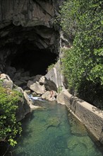 Person exploring entrance ot cave, Cueva del Gato, Benaojan, Serrania de Ronda, Malaga province,