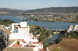 Reservoir lake occupying flooded valley land, village of Arcos de la Frontera, Cadiz province,