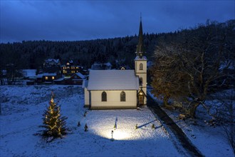 A Christmas tree stands in front of the smallest wooden church in Germany, Elend, 29 December 2020