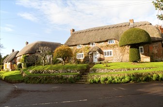 Attractive traditional thatched cottages in village of Woodborough, Wiltshire, England, UK