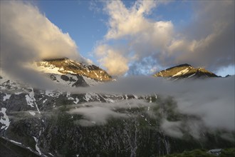 Cloudy mountain landscape in dramatic morning light, summit Hochsteller and Griesferner with snow,