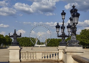 Ferris wheel as seen from the platform of the Monument aux Girondins with lanterns in Bordeaux,